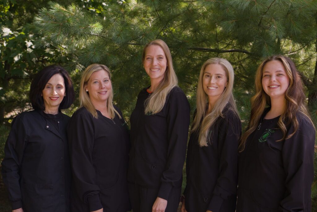 The Cedars Family Dental team in front of the pines outside the practice