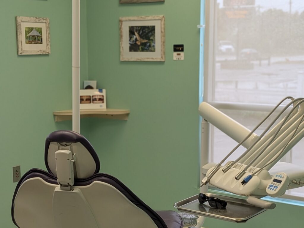 A second treatment room, with framed work by local artists on the wall above the chair