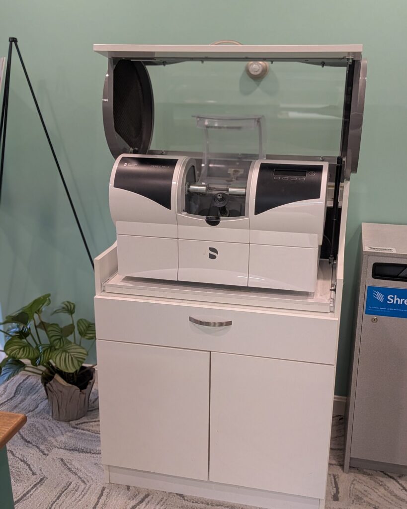 The CEREC milling unit in the office, which shapes a ceramic crown while the patient waits