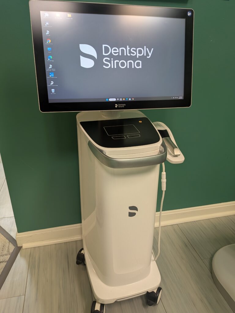 The office's Dentsply Sirona intraoral scanner on its wheeled cart